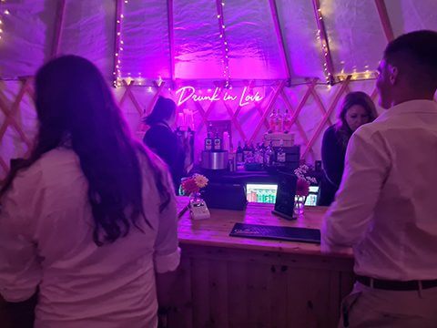 Yurt Bar with neon pink sign