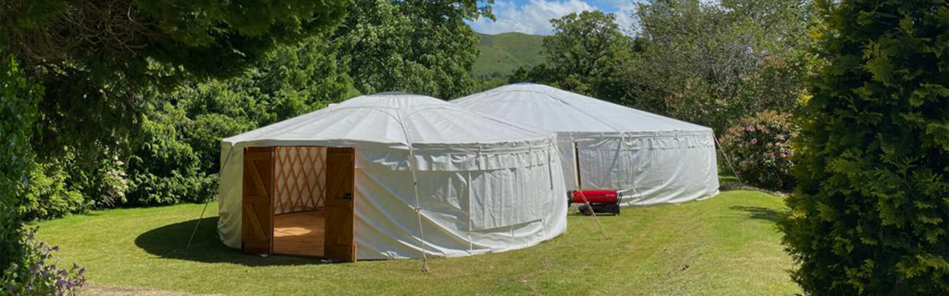 Two Connecting Yurts in a enclosed field